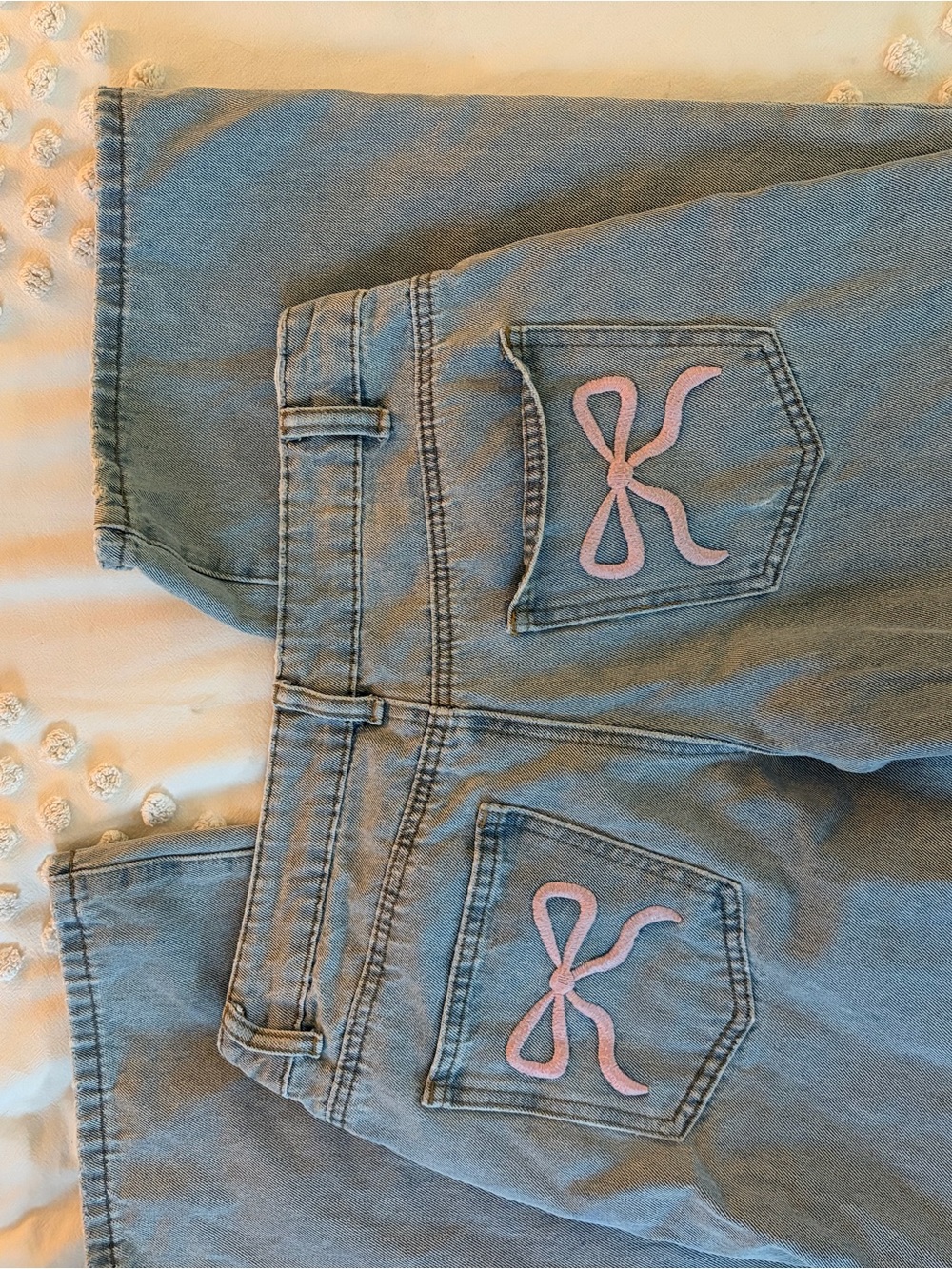 Edikted Light Wash Jeans with Pink Embroidered Bow Detail